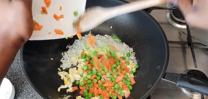 Add the frozen peas and carrots and mix well until softened. Cook on medium-low heat to prevent burning.