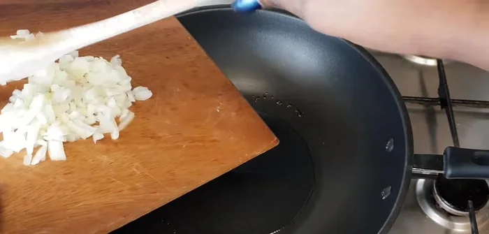 Reduce heat to medium. Add the chopped onion and garlic, and fry until softened (about 1 minute).