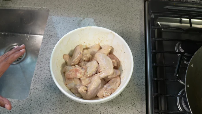 Toss the chicken wings in the marinade and let them marinate for at least 2 hours. Bring to room temperature before frying.