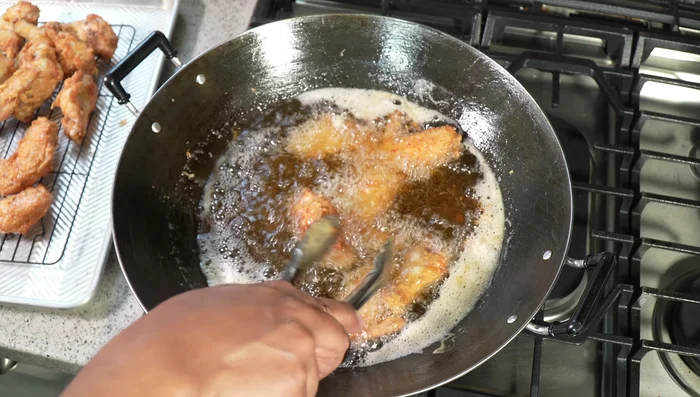 Increase the oil temperature to 350°F (175°C). Fry the wings again for another 3-4 minutes until golden brown and crispy.