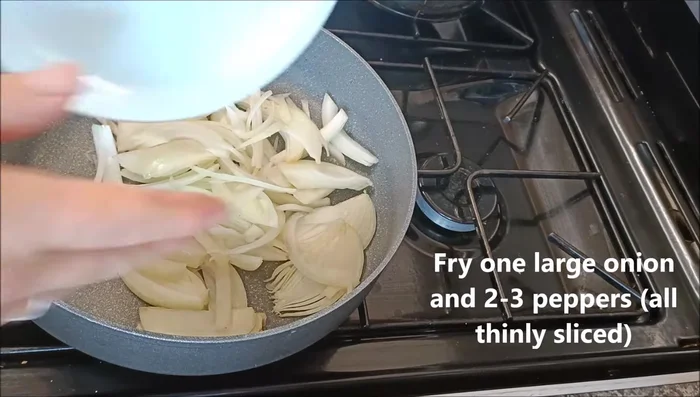 Fry one large onion with two to three peppers (thinly sliced) until soft. (Use oil, spray oil, or water).