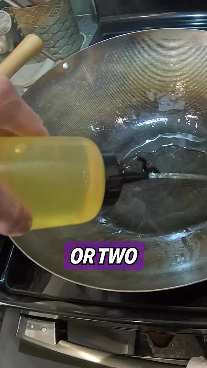 Add about a tablespoon or two of cooking oil to the wok and add the pork. After a minute, add the garlic and toss everything around for 30 seconds.