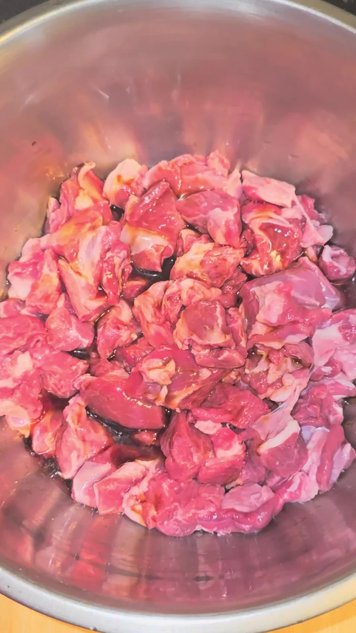 Toss lamb in a bowl with soy sauce, sugar, sesame oil, cumin, chili flakes, salt, minced garlic, and ginger. Mix well and let rest for at least 30 minutes (longer for more flavor).