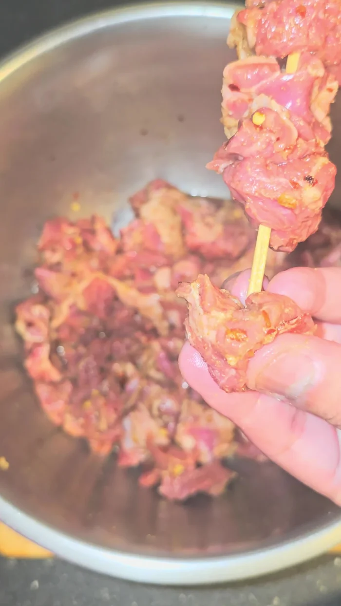 Thread lamb onto skewers, leaving space between pieces for crisping.