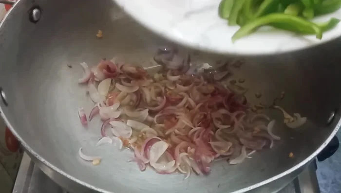 Add your choice of vegetables (cabbage, carrots, capsicum are suggested) and sauté until tender-crisp. Season with salt, garam masala, and black pepper. (Optional: Add green chilies for extra spice).