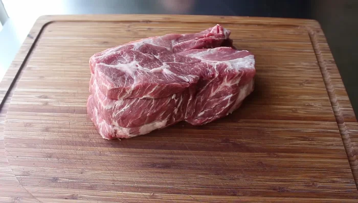 Prepare the pork: Cut the pork shoulder or loin into roughly equal-sized pieces. The size should allow for good surface area but avoid drying out.