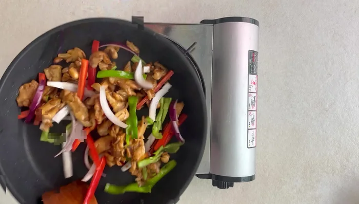 Add the cooked chicken to the sauce and stir to coat.