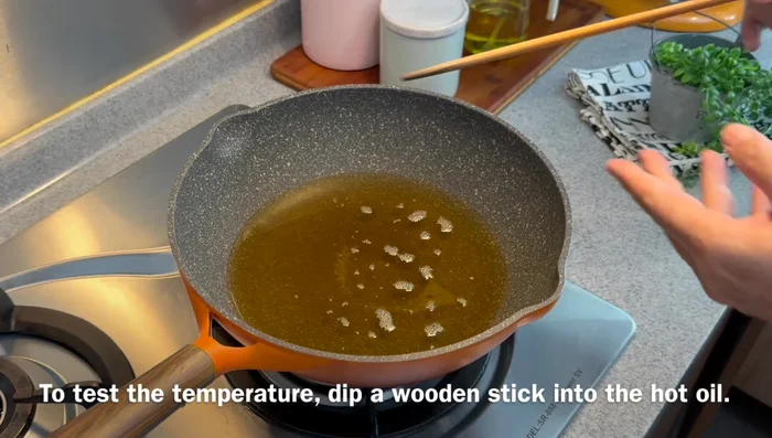Deep fry prawns (first fry): Heat oil until a chopstick inserted creates rapid bubbles. Fry prawns in batches, until they turn red and a crust forms (1-2 minutes per side).