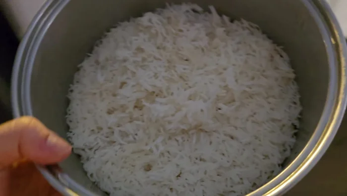 Use 4 cups of cold, day-old cooked long-grain rice. Break it apart and add to the pan with cooking oil. (134.64)
