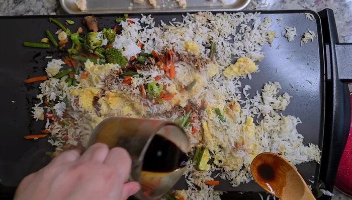 Pour soy sauce mixture over the rice, adding more as needed. Stir in sesame oil and the green tops of the scallions. (235.92)