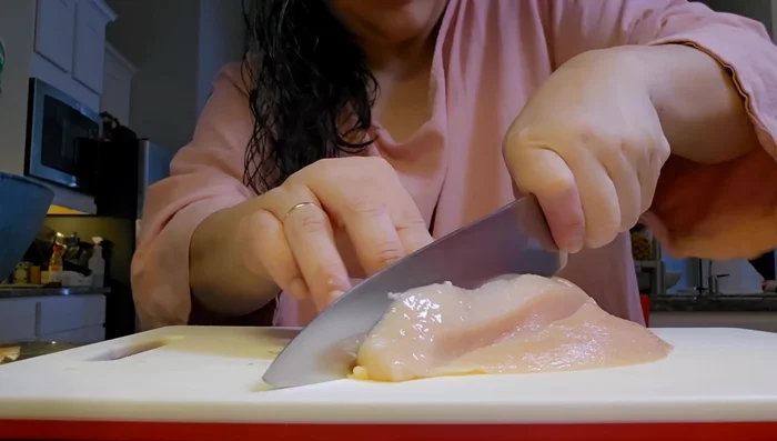 Preheat griddle. Chop two chicken breasts into medium to small cubes. Marinate chicken with shaoxing cooking wine, garlic, pepper, salt, onion powder, and optional MSG for several hours. (19.039)