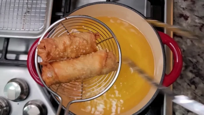 For the egg rolls: Prepare a flavorful pork filling by marinating pork with a mixture of five-spice powder, white pepper, onion powder, garlic powder, hoisin sauce, oyster sauce, sugar, cooking wine, and light soy sauce. (350.44)