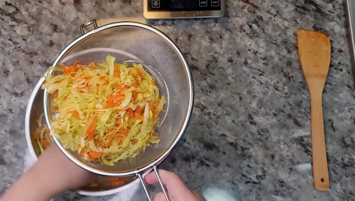 Combine the cooked pork with the cabbage and carrot mixture, pressing out excess moisture from the vegetables. (583.88)