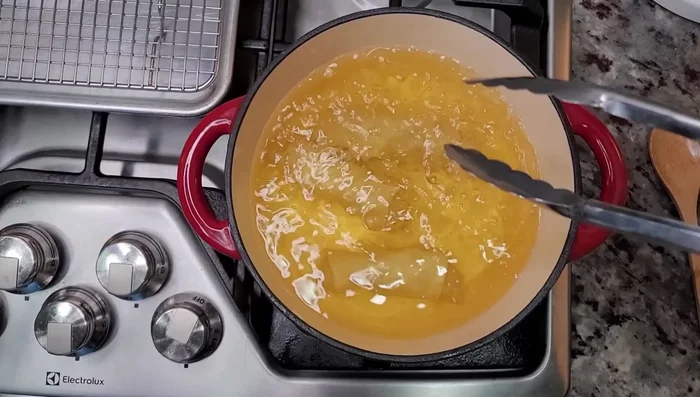 Deep-fry egg rolls in hot oil until golden brown and crispy. (707.079)