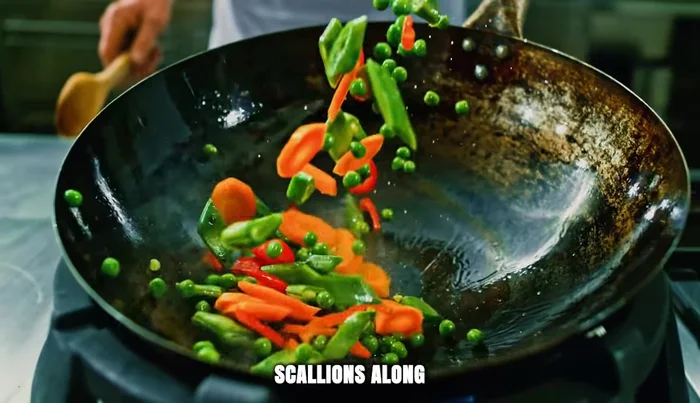 Add white parts of scallions, carrots, and green beans. Stir quickly until slightly softened.