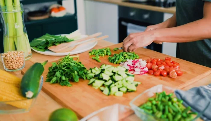 Chop vegetables: 1 medium carrot, a handful of green beans, 1/2 cup diced bell pepper, 1 cup shredded napa cabbage, and 1/2 cup green peas or edamame.