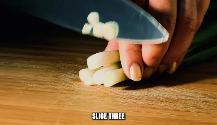 Slice 3 scallions, keeping the green tops and white bottoms separate.