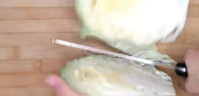 Shred the cabbage into thin strips. (Note: The transcript doesn't explicitly detail the preparation steps, these are inferred from the recipe title and common cabbage stir-fry techniques.)