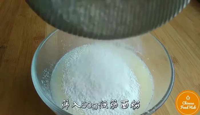Pour batter into prepared baking sheet. (Note: Transcript mentions baking sheet but does not explicitly describe preparation)