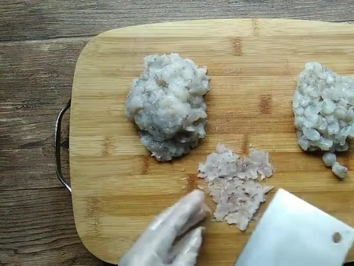 Prepare the shrimp and pork filling. Mince the shrimp, pork, ginger, garlic, and green onions. Mix well with soy sauce, sesame oil, and cornstarch.
