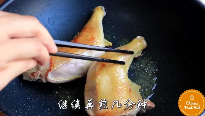 Heat oil in a pot: Add the marinated chicken drumsticks.