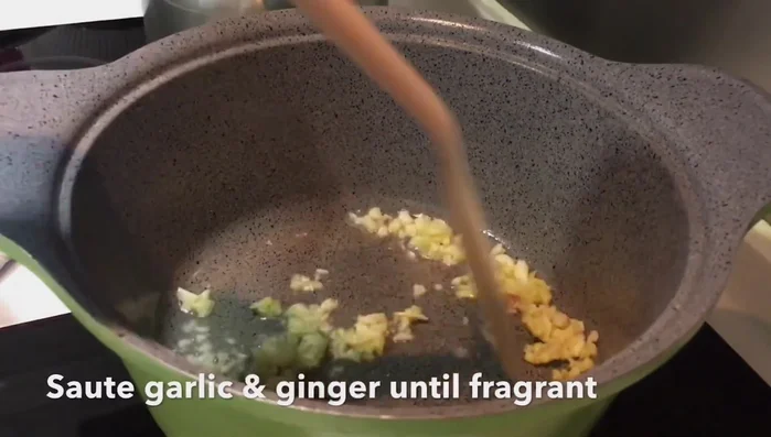 Add chopped onions and carrots, stir-fry until softened.