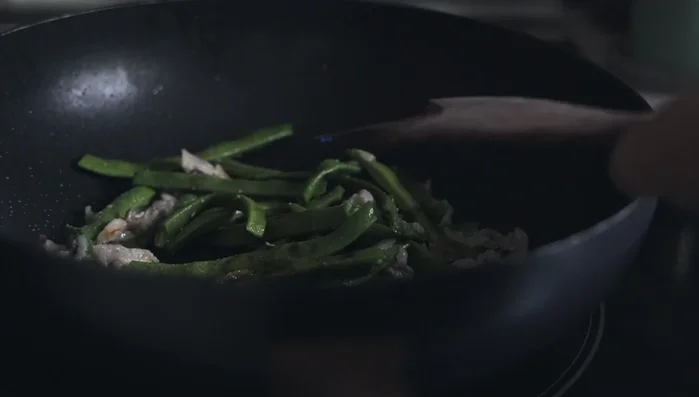 Add soy sauce generously (using a spatula), then sake (double the amount of soy sauce), tossing to prevent burning.
