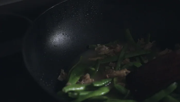 When the green beans wilt, add enough chicken stock to cover. Bring to a boil, then add the noodles.