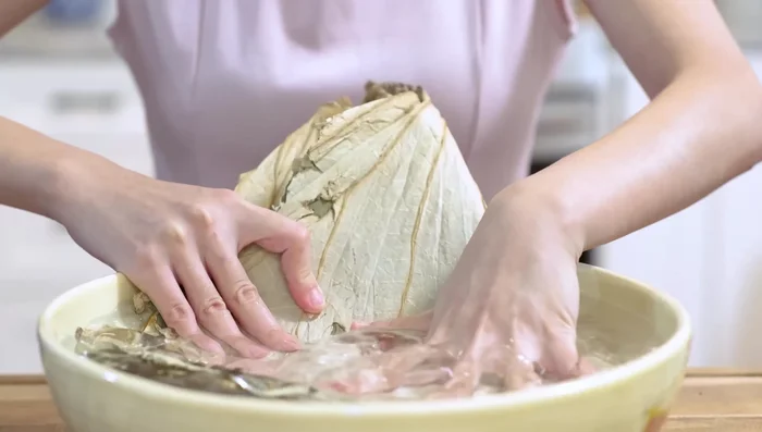 Soak lotus leaves for 2 hours until soft and pliable.