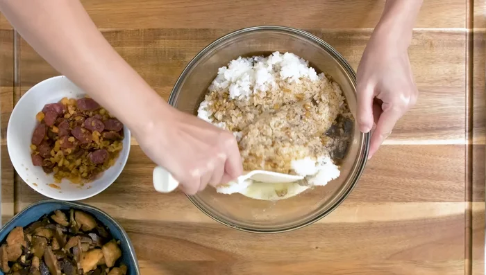 Mix cooked rice with chicken, mushroom sauce, and other ingredients.