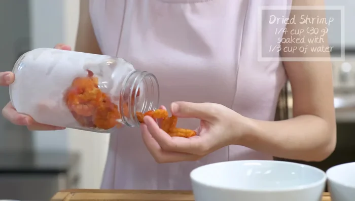Soak dried shiitake mushrooms (8 pieces) in 1 cup of water and dried shrimp (0.25 cups) in 1.75 cups of water for about 2 hours.
