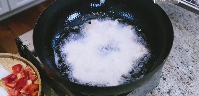 Heat oil in wok to 400°F. Fry beef slices in batches until golden brown, about 1 minute per side.