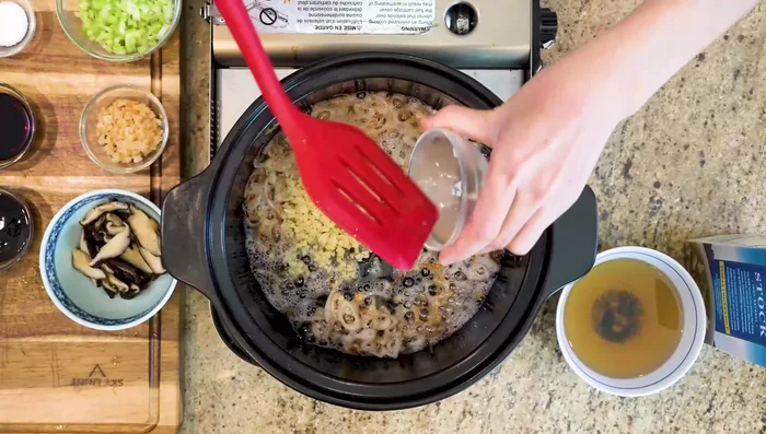 Add minced garlic, stir-frying until golden brown.
