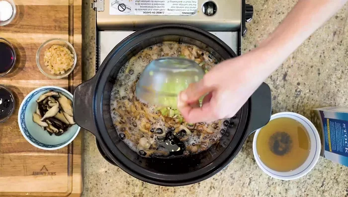 Add diced celery, dried shrimp, and shiitake mushrooms; stir-fry to activate aroma.