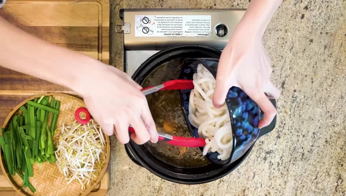 Add carrots to the pot, followed by noodles. Cook until noodles are tender.