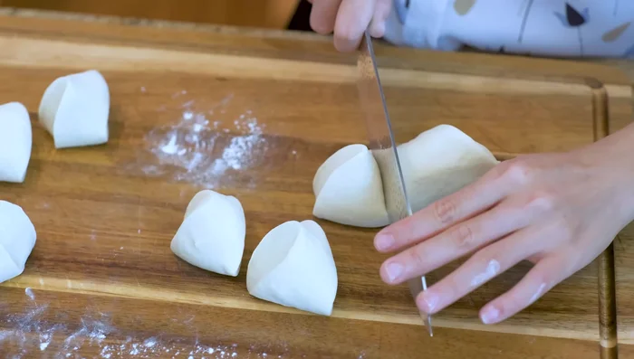 Divide dough into 10 equal pieces (50-55g each). Roll into balls.