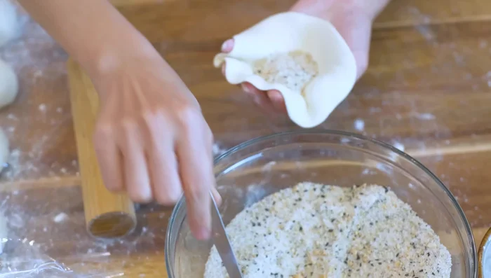 Fill each wrapper with 2 tablespoons of filling. Pinch and pleat the edges to seal.