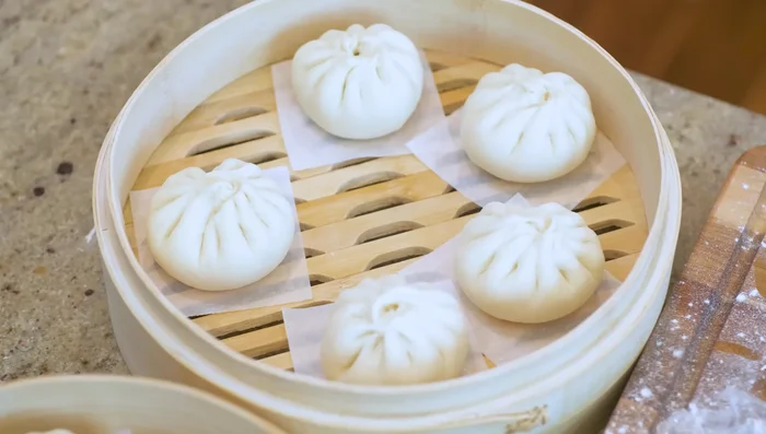 Place buns in a steamer lined with parchment paper. Let proof for 30 minutes.