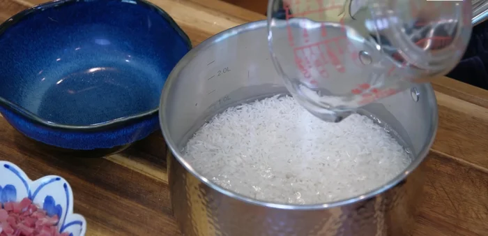 Cook the rice: In a saucepan, combine rice and water. Bring to a simmer over high heat, then reduce heat to low, cover, and cook for 18 minutes.