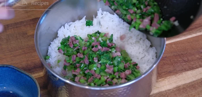 Combine rice and vegetables: Fluff the cooked rice with a spatula. Add the sautéed vegetables and ham. Mix well.