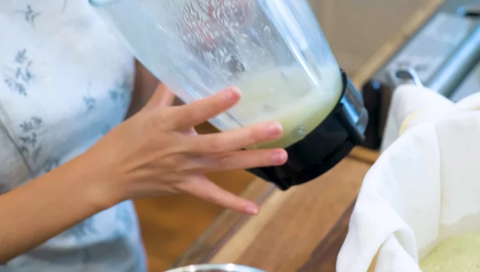 Line a sieve with cheesecloth. Pour the hot puree into the sieve and squeeze out as much liquid as possible, rinsing with the remaining salt water solution. This takes about 15 minutes.