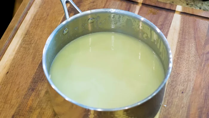 Discard the solids. Simmer the extracted oyster liquid in a large pot until reduced to a thick, light brown consistency (approximately 1-1.5 hours).