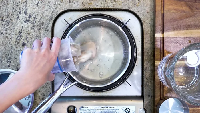 Add oysters (including their liquid) to the pot. Add 1 cup of the salt water solution. Bring to a boil, then simmer for 5 minutes on low heat.