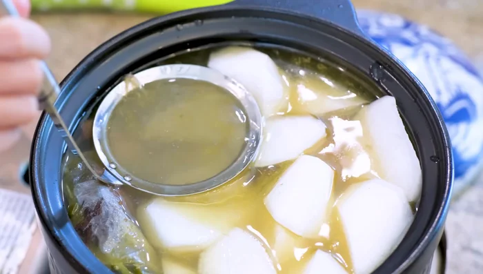 Skim off excess fat from the broth using a fine sieve.