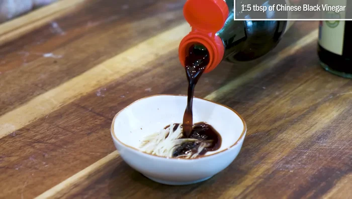 Make dipping sauce by combining ginger, black vinegar, and soy sauce.
