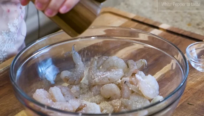 Season shrimp with salt and pepper. Reserve half for garnish; finely smash the rest into a paste.