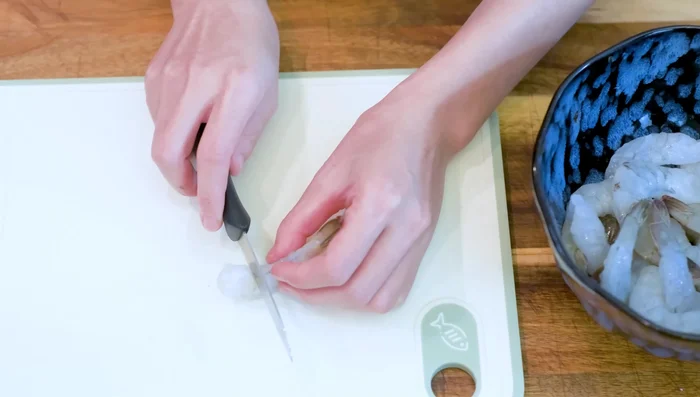 Prepare shrimp: Make slits on the underside of shrimp, marinate, refrigerate.