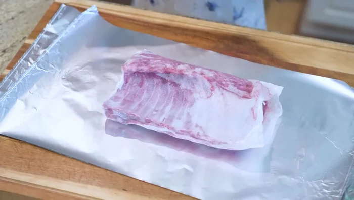 Prepare lamb ribs: Apply dry rub, wrap in tin foil (meat side down), refrigerate overnight.