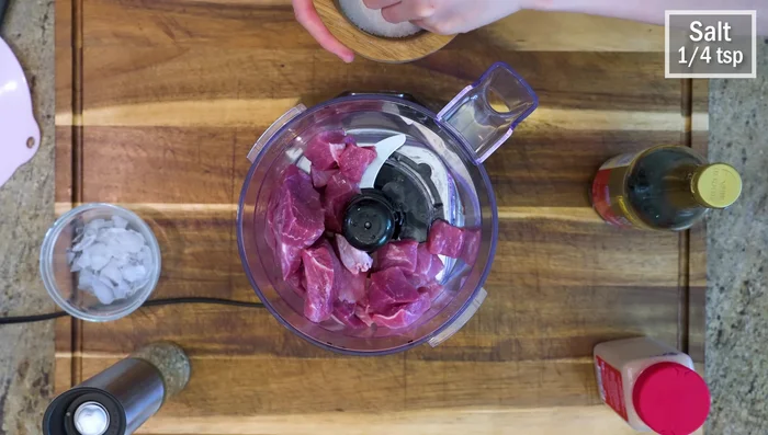 Prepare pork shoulder filling for cabbage rolls: Process in food processor with ice to keep it cool.