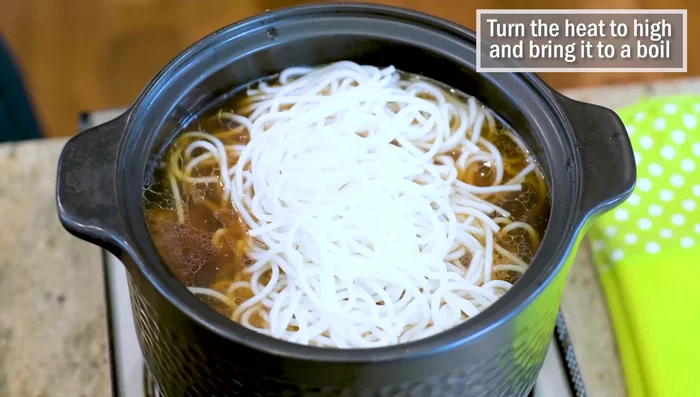 Add Noodles and Vegetables: Add the drained noodles and baby bok choy to the braising liquid. Bring to a boil and cook for 20-30 seconds.